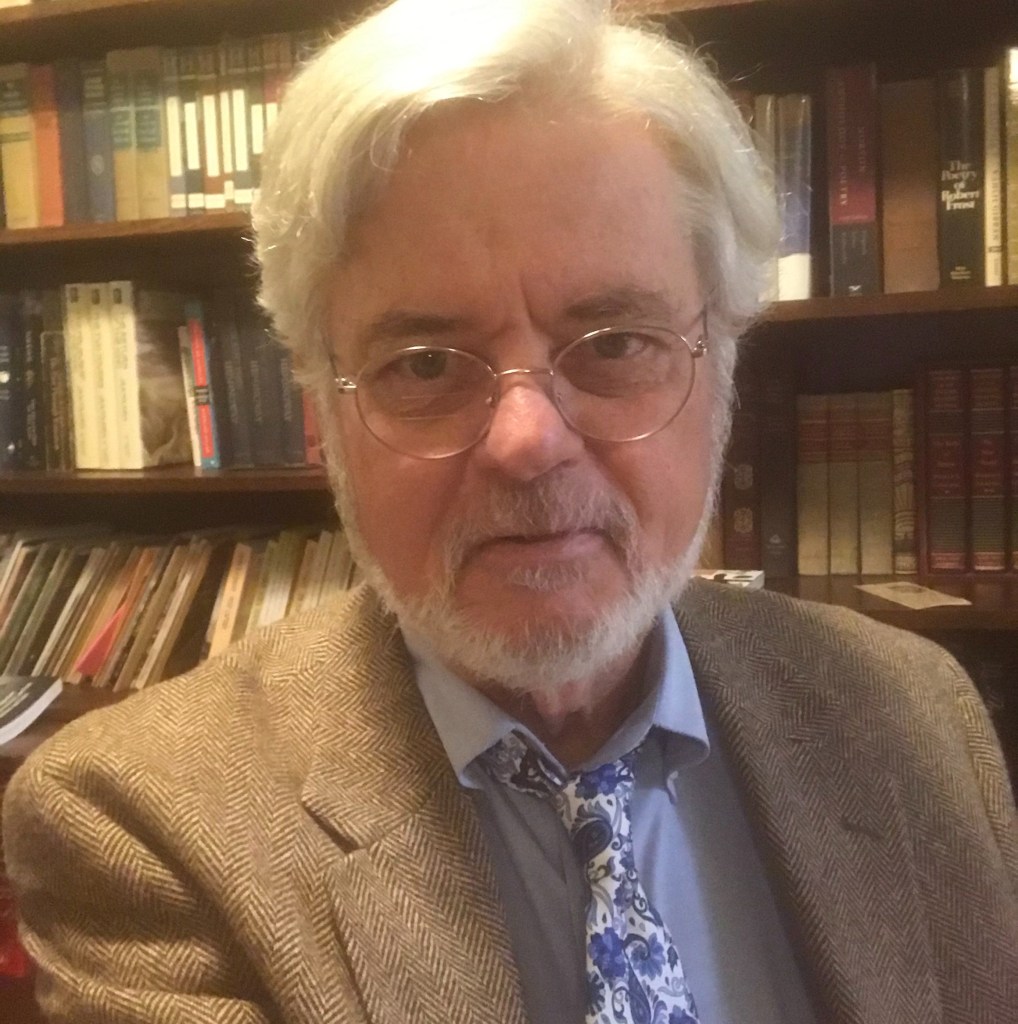 Robin Cravey in front of bookshelves